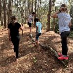 children hiking, some barefoot, during OT session