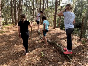children hiking, some barefoot, during OT session