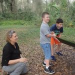 occupational therapist providing verbal cues to children outdoors