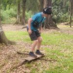 outdoor OT for kids, child balancing on board