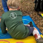 child sitting in side sit on mat