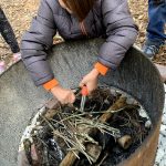 child working on starting a fire during OT session