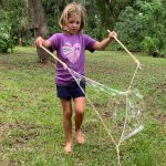 Girl making giant bubbles