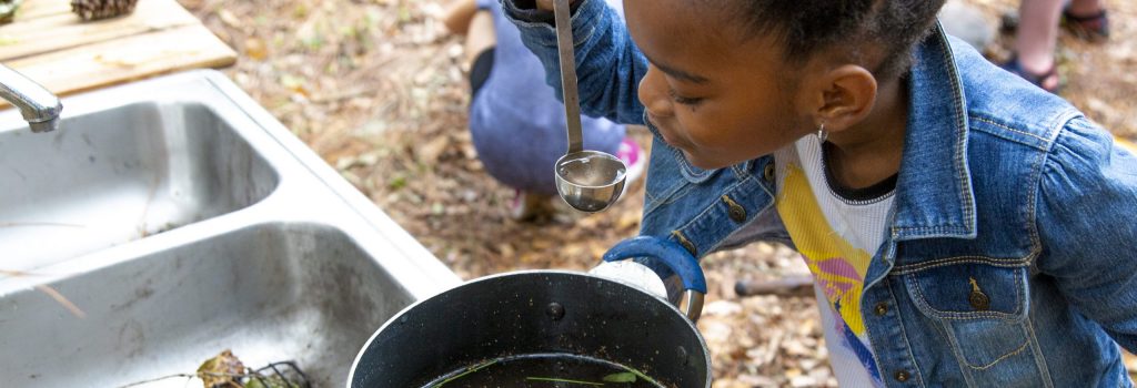 Central Florida Outdoor Therapy and Play; child playing in the mud kitchen