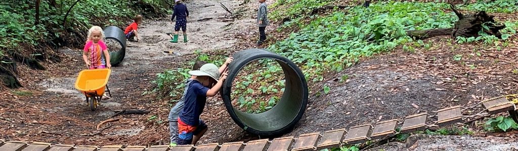 Kids playing in the dry creekbed at Treeline Enrichment