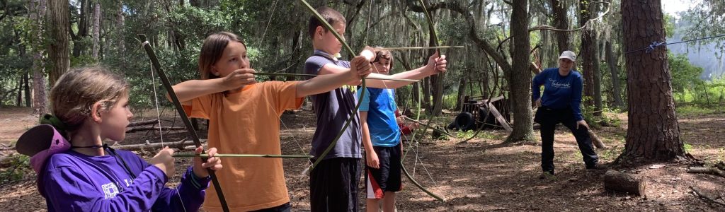 Image of kids palm arrows from palm bows that they made.