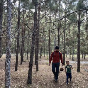 OT student walking with child in pine trees