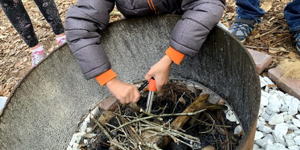 child working on starting a fire during OT session