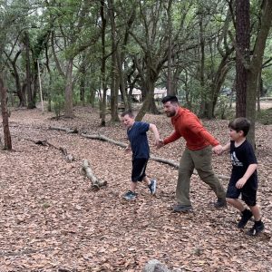 OT student playing blob tag with 2 kids